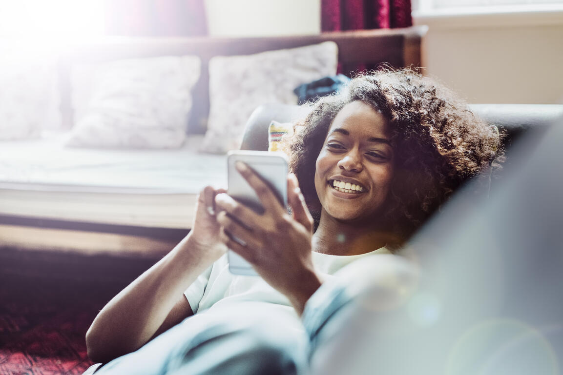 Woman on sofa blogging