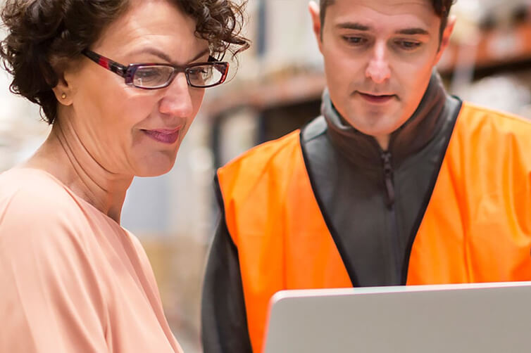 Warehouse workers on laptop