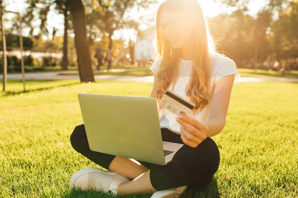 Woman sitting outside shopping online